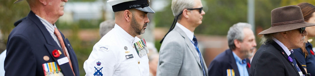 Current serving and veterans standing at an ANZAC Day service